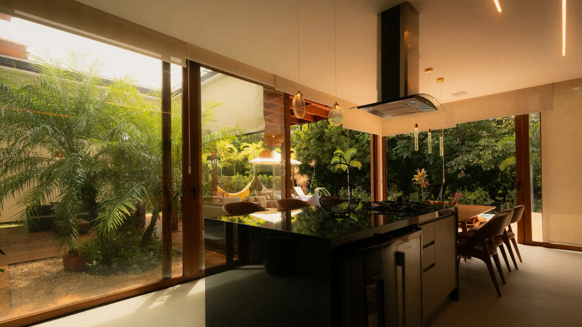 Kitchen opening onto a tropical courtyard garden